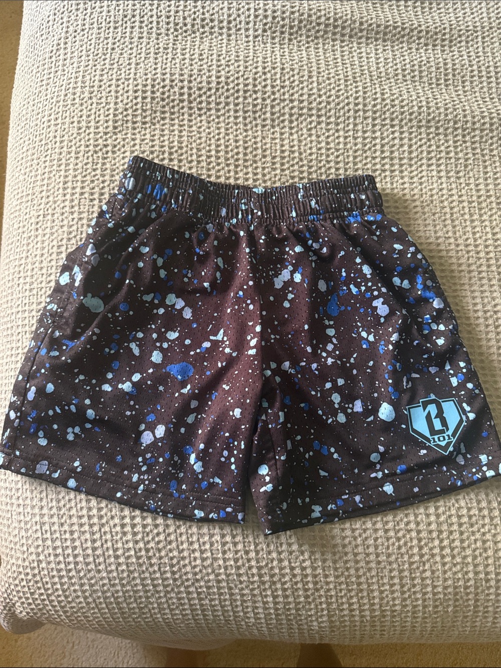 Kids Black Splatter Athletic Shorts with Blue Accents